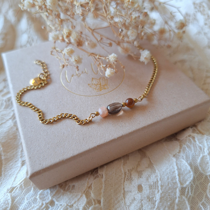 Close-up van Heb Vertrouwen armband op kant met natuurlijk takje